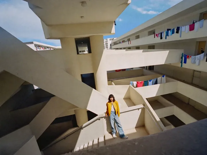 Official Cutout example frame showing a person inside a geometric apartment courtyard.